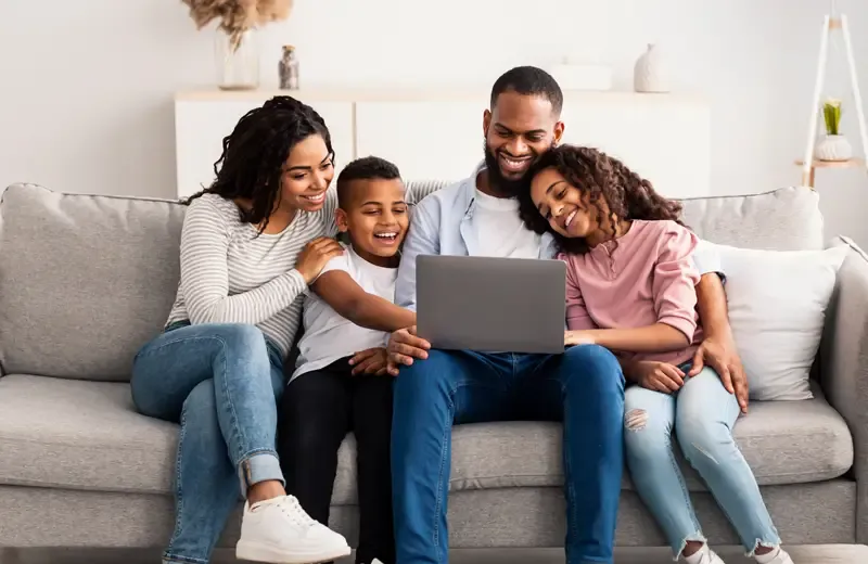 family watching tv and laughing